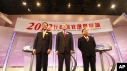 Hong Kong Chief Executive candidates (L-R) Leung Chun-ying, Henry Tang and Albert Ho stand on the stage after a live television debate in Hong Kong, March 16, 2012.
