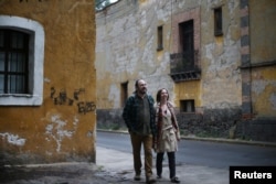 Alejandra, 44, an education policy consultant and Razhy, 48, a journalist and a human rights activist, walk on a street in the Coyoacan neighborhood, in Mexico City, Mexico, Feb. 9, 2018.