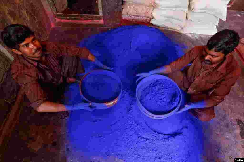 Workers sieve colored powder before being packed for sale inside a workshop ahead of Holi, the Festival of Colors in Kolkata, India.