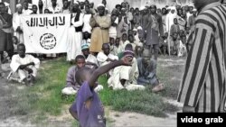 A young boy is flogged in a public square by a Boko Haram militant.