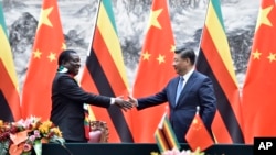 FILE: Zimbabwean President Emmerson Mnangagwa, left, shakes hands with Chinese President Xi Jinping as they pose for the media after a signing ceremony at the Great Hall of the People in Beijing, China, April 3, 2018.