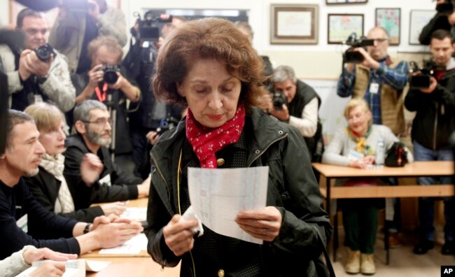 Gordana Siljanovska Davkova, a presidential candidate for the opposition conservative VMRO-DPMNE party, looks at her ballot before voting for the presidential election at a polling station, in Skopje, North Macedonia, May 5, 2019.
