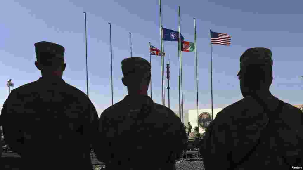 U.S. Marines stand at attention during a handover ceremony, as the last U.S. Marines unit and British combat troops end their Afghan operations, in Helmand province, Oct. 26, 2014. 