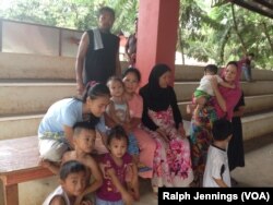 Displaced people from Marawi City, Philippines, sit outside an evacuation center two hours away, Nov. 15, 2017. The fate of as many as 364,000 evacuees from Marawi will challenge government agencies.