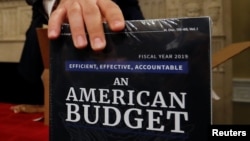 Copies of the President Trump's FY 2019 budget proposal are delivered to the U.S. House Budget Committee offices on Capitol Hill in Washington, Feb. 12, 2018. 