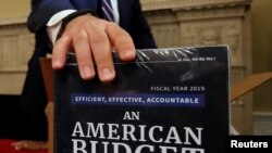 Copies of the President Trump's FY 2019 budget proposal are delivered to the U.S. House Budget Committee offices on Capitol Hill in Washington, Feb. 12, 2018. 