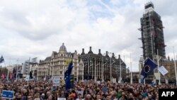 Crowds gather after the march to listen to speakers at a rally organized by the pro-European People's Vote campaign for a second EU referendum in Parliament Square, central London, March 23, 2019.