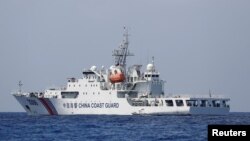 FILE - A China Coast Guard vessel patrols at the disputed Scarborough Shoal April 6, 2017. (REUTERS/Erik De Castro)