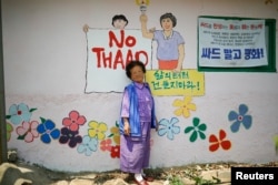 Do Geum-ryeon poses for photographs during an anti-THAAD protest, in Seongju, South Korea, June 14, 2017.