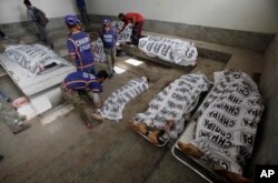 Bodies of alleged militants killed in an operation by security forces are tended to by workers from the Chhipa Welfare Association, at a mortuary in Karachi, Pakistan, Feb. 22, 2017. Rao Anwar, a police official in Karachi, said eight Taliban-linked militants were killed in the raid.