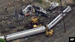 Emergency personnel work at the scene of a deadly train derailment, Wednesday, May 13, 2015, in Philadelphia. The Amtrak train, headed to New York City, derailed and crashed in Philadelphia on Tuesday night, killing at least six people and injuring dozens