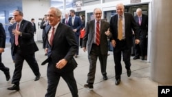 From left, Sens. Mark Pryor, D-Ark., Bob Corker, R-Tenn., James Risch, R-Idaho, John McCain, R-Ariz., and Orrin G. Hatch, R-Utah, rush to the Senate floor for a procedural vote, ahead of a midnight deadline to keep the government running, Dec. 11, 2014.