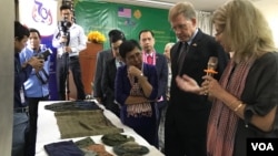 U.S. Ambassador to Cambodia W. Patrick Murphy and Culture Minister Phoeurng Sackona listen to an expert's explanation describing ways of preserving textiles belonging to victims of S-21 prison at Toul Sleng Genocide Museum, in Phnom Penh, Cambodia, (Hul Reaksmey/VOA Khmer)