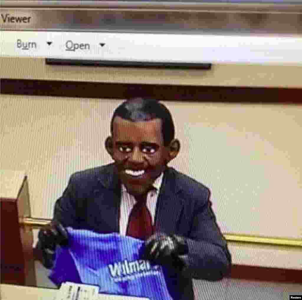 A man wearing a mask of U.S. President Barack Obama robs a Bank of America branch, as seen in this undated surveillance video released on Sept.12, 2013 by the Merrimack Police Department in Merrimack, New Hampshire. John Griffin Jr., 52, was charged with robbing the Bank of America branch while wearing a mask of U.S. President Barack Obama, police said.