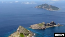 A group of disputed islands, Uotsuri island (top), Minamikojima (bottom) and Kitakojima, known as Senkaku in Japan and Diaoyu in China is seen in the East China Sea, in this photo taken by Kyodo News Service, September 2012.