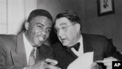 Jackie Robinson and Brooklyn Dodgers President Branch Rickey sign player's agreement