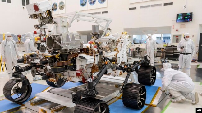 In this Dec. 17, 2019 file photo made available by NASA, engineers monitor a driving test for the Mars rover Perseverance in a clean room at the Jet Propulsion Laboratory in Pasadena, Calif. (J. Krohn/NASA via AP, File)