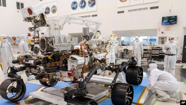 In this Dec. 17, 2019 file photo made available by NASA, engineers monitor a driving test for the Mars rover Perseverance in a clean room at the Jet Propulsion Laboratory in Pasadena, Calif. (J. Krohn/NASA via AP, File)