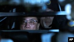 FILE - In this Feb. 20, 2017 photo, Donald Tsang, former leader of Hong Kong, is escorted in a prison bus leaving the high court after sentencing and mitigation after his conviction for misconduct in public office, in Hong Kong.
