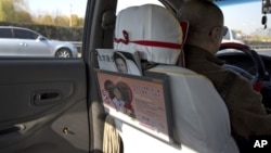 A window handle on the door at the back seat is seen removed in a taxi in Beijing Nov. 1, 2012.