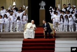 Pope Francis and Colombia's President Juan Manuel Santos confer before a ceremony at the presidential palace in Bogota, Colombia, Sept. 7, 2017.