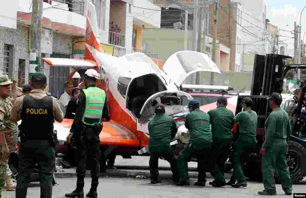 A small Peruvian Air Force plane is seen after it crashed onto a street in Lima, Feb. 4, 2019.