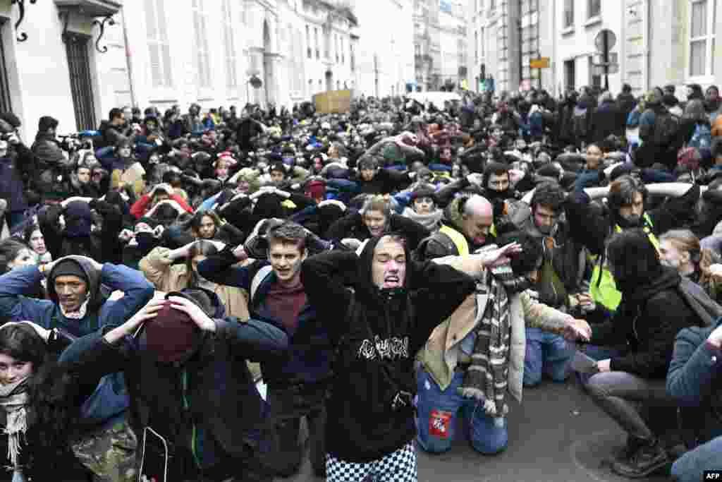 High school students demonstrate on their knees in Paris, France, to protest against the different education reforms including the overhauls and stricter university entrance requirements.