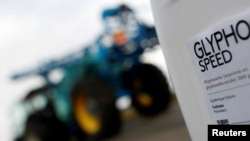 FILE - A can of glyphosate weedkiller is seen in front of a tractor with a pulverizer system as French farmer Herve Fouassier is interviewed by Reuters in Ouzouer-sous-Bellegarde, France, Nov. 30, 2017.