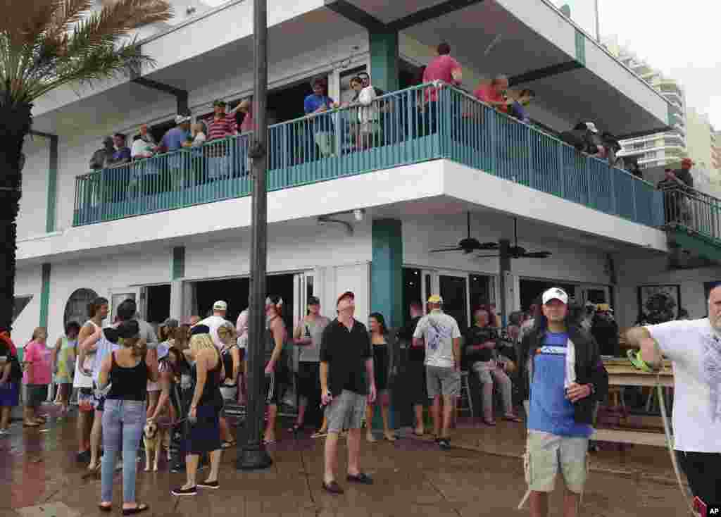 With Hurricane Matthew still far off the coast, people party at the Elbo Room bar in Fort Lauderdale, Fla., on Oct. 6, 2016. Dozens of people joined in the festivities and others jogged or swam in the rough surf as Matthew appeared headed well north of th