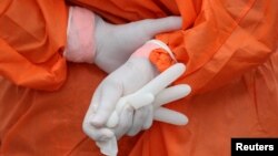 A health worker holds a glove outside the San Jose public hospital emergencies entrance, amid the spread of the coronavirus disease (COVID-19) in Santiago, Chile, May 28, 2020.