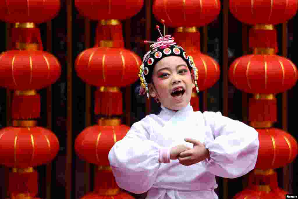 A child performs opera during celebrations on the eighth day of Chinese Lunar New Year of the Pig, in Taizhou, Zhejiang province, China.