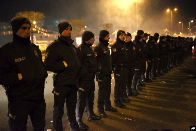 Security officers keep watch at the Republican People's Party, or CHP, headquarters during a local elections rally in Ankara, Turkey, early Monday, April 1, 2019.