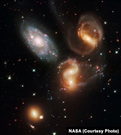 Four of these five galaxies in Stephan's Quintet are so close together they are bound together by gravity and will eventually merge into a single galaxy. The galaxy at top left is in the foreground, far from the other members.