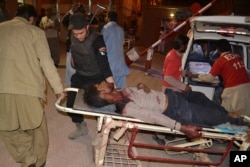 Pakistani volunteers rush an injured person to a hospital in Quetta, Pakistan, Oct. 24, 2016.