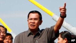 Cambodia's Prime Minister Hun Sen, center, gestures during a ceremony inaugurating the country's longest bridge in Neak Loeung, southeast of Phnom Penh, Cambodia, Wednesday, Jan. 14, 2015. 