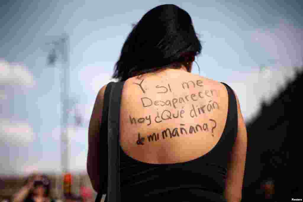 A woman takes part in a demonstration in Mexico City, demanding justice for the female victims of violence in Mexico, Feb. 25, 2018. The words written on her back read: &quot;And if I disappear today, what would they say about me tomorrow?&quot;.