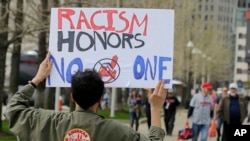 Josh Hunt protests as fans walk to the ballpark before a baseball game, Tuesday between the Chicago White Sox and the Cleveland Indians, April 11, 2017, during opening day in Cleveland. Hunt is from the Cheyenne and Arapaho Tribe