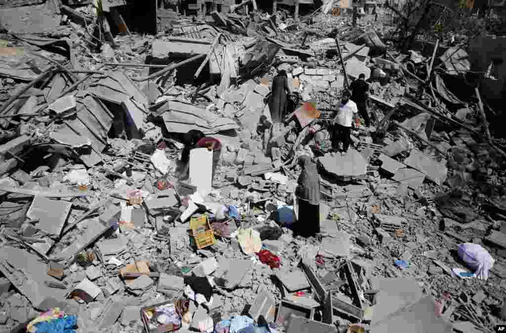 Palestinians search the rubble that was their home, in Beit Hanoun, Gaza Strip, Aug. 1, 2014.