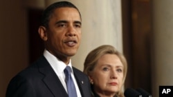 U.S. President Barack Obama with U.S. Secretary of State Hillary Clinton (right) speaks about Libya at the White House,. February 23, 2011
