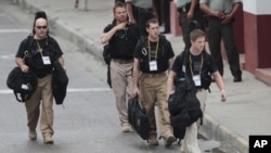 U.S. secret service agents walk around the Convention Center in Cartagena, Colombia, prior to the opening ceremony of the 6th Summit of the Americas, April 14, 2012. 