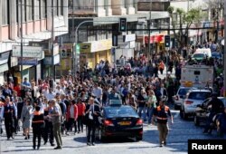 Citizens take part in a mass evacuation during a simulated disaster by a fictitious tsunami to mark World Tsunami Day on the Pacific coast in Valparaiso, Chile Nov. 3, 2016.