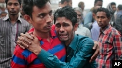 Bangladeshi people cry as rescuers search the Padma river after a passenger ferry capsized in Manikganj district, about 40 kilometers (25 miles) northwest of Dhaka, Bangladesh, Feb. 23, 2015. 