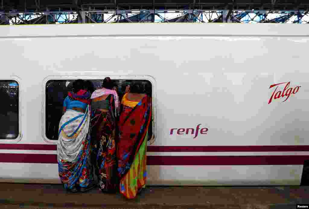 People look inside the parked high speed Talgo train during its trial run at a railway station in Mumbai, India.