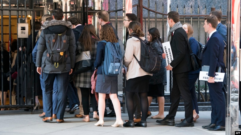 FILE - A group of students enters the building that houses the Russian Mission to the United Nations in New York for a tour, March 26, 2018. Russia is urging about 60,000 of its citizens studying abroad to return home.