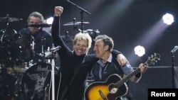 Singers Bon Jovi (L) and Bruce Springsteen perform during the '12-12-12' benefit concert for victims of Superstorm Sandy