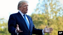 President Donald Trump speaks to reporters upon his return to the White House in Washington, Sunday, Sept. 24, 2017. 