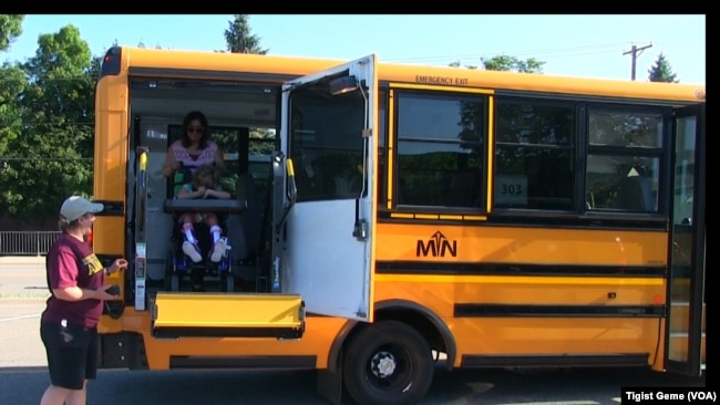 A Metropolitan Transportation Network bus picks up students for summer school in Minnesota, Aug. 8, 2017.