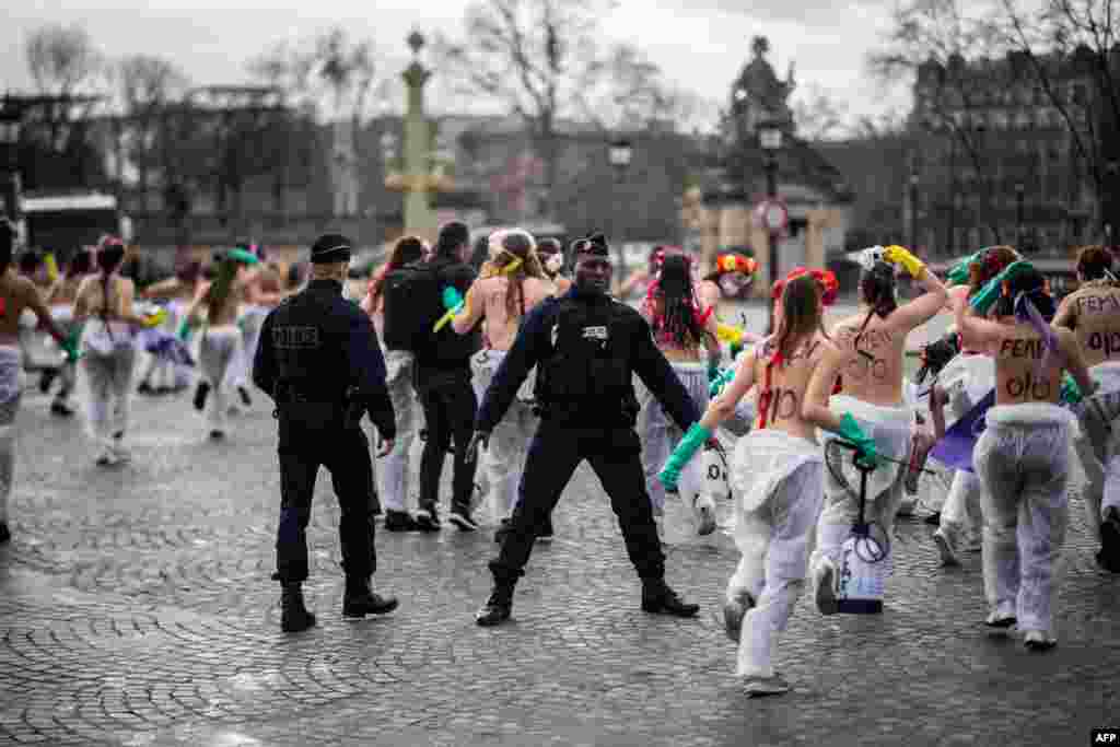 Femen activists demonstrate at place de la Concorde in Paris, to call for gender equality on the International Women&#39;s day.