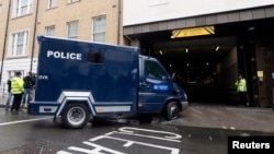 A police van thought to be carrying Michael Adebowale arrives at Westminster Magistrates Court in London, May 30, 2013. 