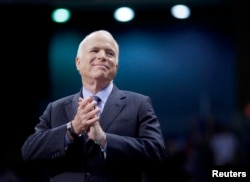 FILE - U.S. Republican presidential nominee Senator John McCain of Arizona listens as he is introduced at a campaign rally in Fayetteville, N.C., Oct. 28, 2008.